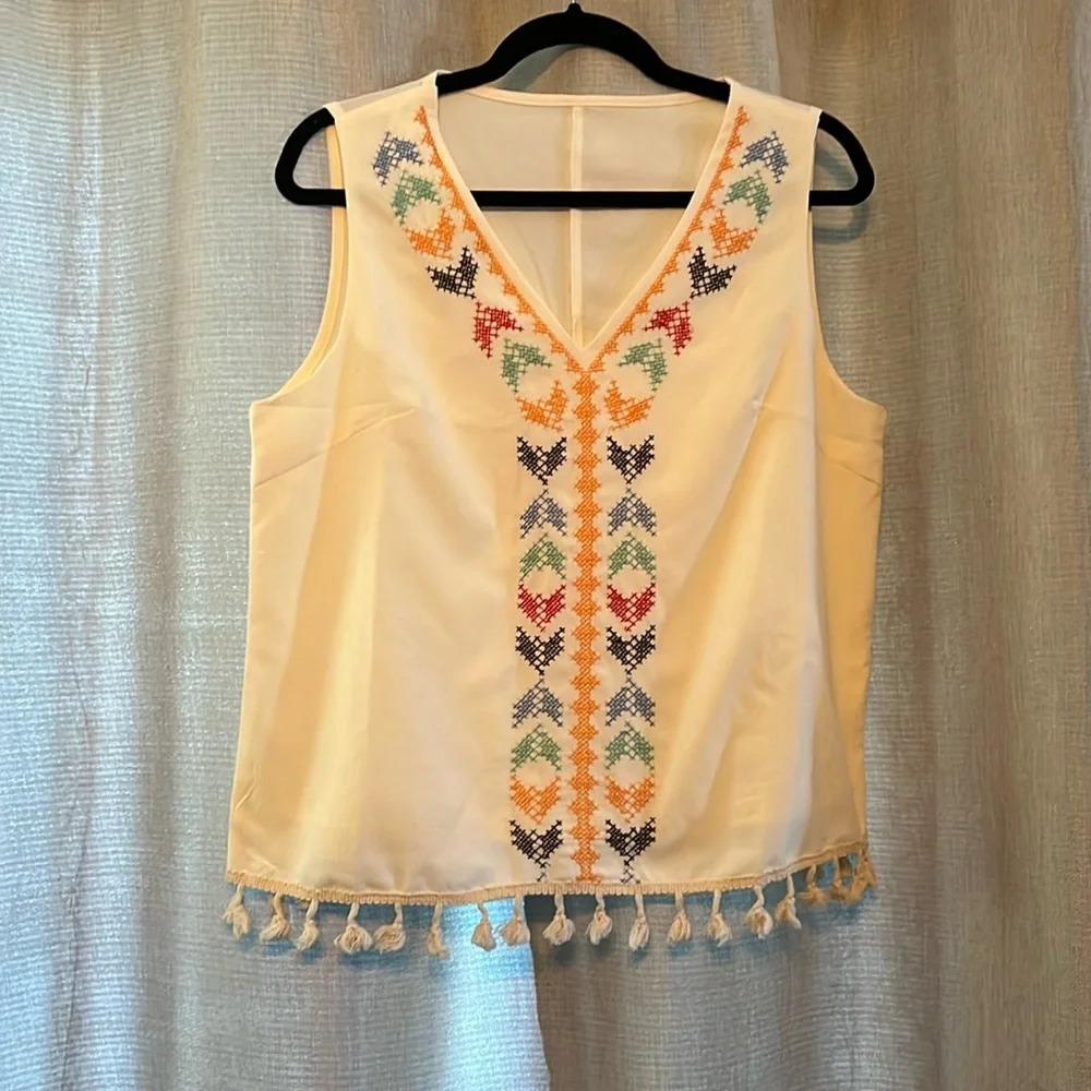 Adorable size medium sleeveless blouse with cross stitching, and fringe